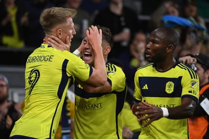 Mar 16, 2024; Nashville, Tennessee, USA; Nashville SC forward Sam Surridge (9) celebrates with defender Taylor Washington (23) after a goal during the first half against Charlotte FC at Geodis Park. Mandatory Credit: Christopher Hanewinckel-USA TODAY Sports