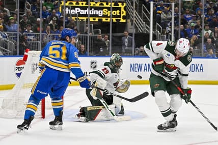 Mar 16, 2024; St. Louis, Missouri, USA;  Minnesota Wild goaltender Marc-Andre Fleury (29) and defenseman Jon Merrill (4) defend the net against St. Louis Blues defenseman Matthew Kessel (51) during the second period at Enterprise Center. Mandatory Credit: Jeff Curry-USA TODAY Sports