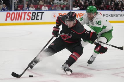 Mar 16, 2024; Toronto, Ontario, CAN; Carolina Hurricanes defenseman Dmitry Orlov (7) controls the puck against Toronto Maple Leafs forward Noah Gregor (18) during the third period at Scotiabank Arena. Mandatory Credit: John E. Sokolowski-USA TODAY Sports