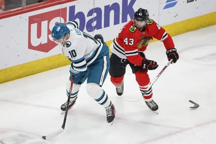 Mar 17, 2024; Chicago, Illinois, USA; San Jose Sharks center Klim Kostin (10) keeps the puck away from Chicago Blackhawks center Colin Blackwell (43) during the first period at United Center. Mandatory Credit: Kamil Krzaczynski-USA TODAY Sports