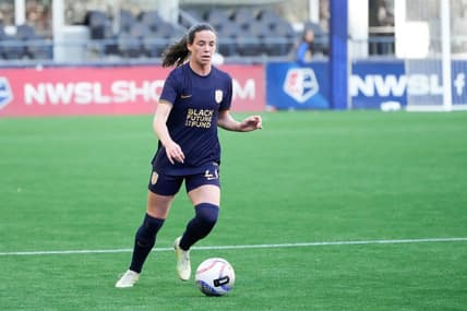 Mar 17, 2024; Seattle, Washington, USA; Seattle Reign defender Phoebe McClernon (21) dribbles against the Washington Spirit during the first half at Lumen Field. Mandatory Credit: Stephen Brashear-USA TODAY Sports