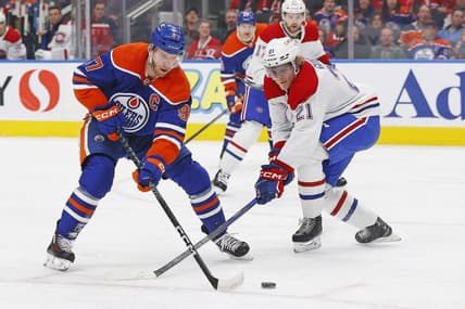 Mar 16, 2024; Edmonton, Alberta, CAN; Edmonton Oilers forward Connor McDavid (97) tries to carry the puck around Montreal Canadiens defensemen Kaiden Guhle (21) during the first period at Rogers Place. Mandatory Credit: Perry Nelson-USA TODAY Sports