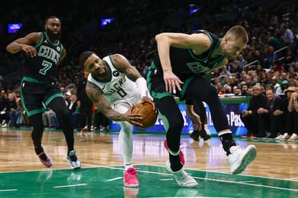 Mar 20, 2024; Boston, Massachusetts, USA; Milwaukee Bucks guard Damian Lillard (0) runs into the back of Boston Celtics center Kristaps Porzingis (8) during the second quarter at TD Garden. Mandatory Credit: Winslow Townson-USA TODAY Sports