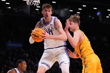 Mar 22, 2024; Brooklyn, NY, USA; Duke Blue Devils center Kyle Filipowski (30) grabs a rebound against the Vermont Catamounts in the first round of the 2024 NCAA Tournament at the Barclays Center. Mandatory Credit: Robert Deutsch-USA TODAY Sports