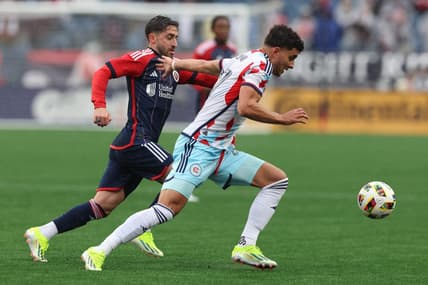 Mar 23, 2024; Foxborough, Massachusetts, USA; Chicago Fire FC defender Allan Arigoni (27) plays the ball defended by New England Revolution midfielder Nacho Gil (21) in the first half at Gillette Stadium. Mandatory Credit: Paul Rutherford-USA TODAY Sports