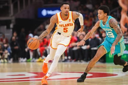 Mar 23, 2024; Atlanta, Georgia, USA; Atlanta Hawks guard Dejounte Murray (5) is defended by Charlotte Hornets guard Tre Mann (23) in the first quarter at State Farm Arena. Mandatory Credit: Brett Davis-USA TODAY Sports