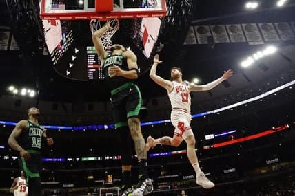 Mar 23, 2024; Chicago, Illinois, USA; Boston Celtics forward Jayson Tatum (0) scores on Chicago Bulls forward Onuralp Bitim (17) during the first quarter at United Center. Mandatory Credit: David Banks-USA TODAY Sports