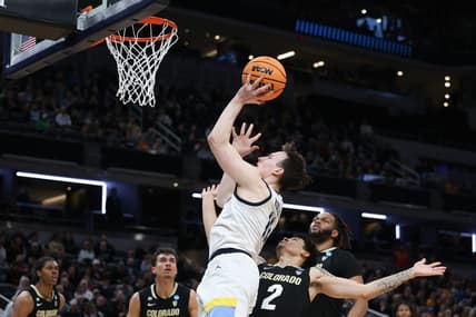 Mar 24, 2024; Indianapolis, IN, USA; Marquette Golden Eagles guard Tyler Kolek (11) shoots over Colorado Buffaloes guard KJ Simpson (2) during the first half at Gainbridge FieldHouse. Mandatory Credit: Trevor Ruszkowski-USA TODAY Sports