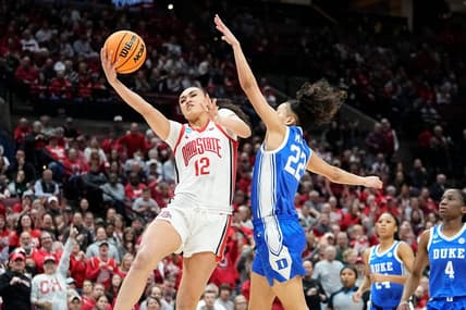 Ohio State guard Celeste Taylor (12) hits a layup around Duke guard Taina Mair (22) during the first half of their women's NCAA Tournament game at Value City Arena.