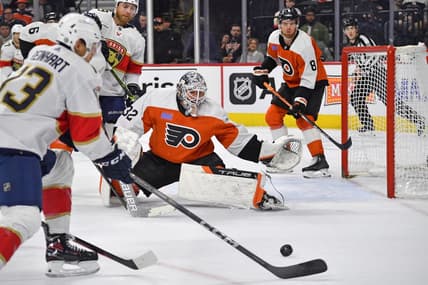 Mar 24, 2024; Philadelphia, Pennsylvania, USA; Philadelphia Flyers goaltender Felix Sandstrom (32) defends as Florida Panthers center Sam Reinhart (13) reaches for the puck during the second period at Wells Fargo Center. Mandatory Credit: Eric Hartline-USA TODAY Sports