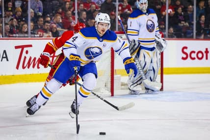 Mar 24, 2024; Calgary, Alberta, CAN; Buffalo Sabres defenseman Bowen Byram (4) controls the puck against the Calgary Flames during the second period at Scotiabank Saddledome. Mandatory Credit: Sergei Belski-USA TODAY Sports