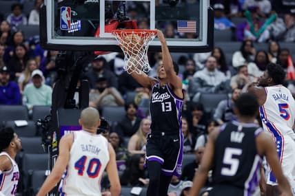 Mar 25, 2024; Sacramento, California, USA; Sacramento Kings forward Keegan Murray (13) dunks the ball against Philadelphia 76ers forward Nicolas Batum (40) during the first quarter at Golden 1 Center. Mandatory Credit: Sergio Estrada-USA TODAY Sports