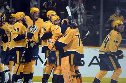Mar 26, 2024; Nashville, Tennessee, USA; Nashville Predators left wing Jason Zucker (16) celebrates with goaltender Juuse Saros (74) after an overtime win against the Vegas Golden Knights at Bridgestone Arena. Mandatory Credit: Christopher Hanewinckel-USA TODAY Sports