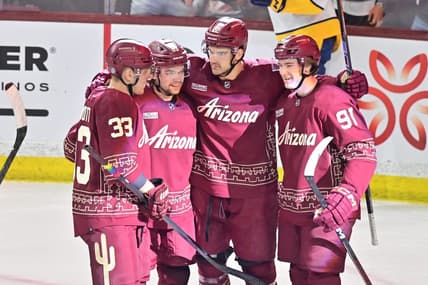 Mar 28, 2024; Tempe, Arizona, USA; Arizona Coyotes center Jack McBain (22) celebrates with right wing Josh Doan (91), left wing Matias Maccelli (63) and defenseman Travis Dermott (33) after scoring a goal in the first period against the Nashville Predators at Mullett Arena. Mandatory Credit: Matt Kartozian-USA TODAY Sports