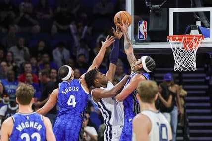 Mar 30, 2024; Orlando, Florida, USA; Orlando Magic forward Paolo Banchero (5) and guard Jalen Suggs (4) block a shot attempt by Memphis Grizzlies forward GG Jackson (45) during the first quarter at KIA Center. Mandatory Credit: Mike Watters-USA TODAY Sports