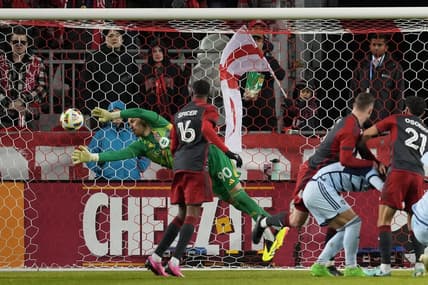 Mar 30, 2024; Toronto, Ontario, USA; Toronto FC goalkeeper Luka Gavran (90) dives to make a stop against Sporting Kansas City during the first half at BMO Field. Mandatory Credit: Nick Turchiaro-USA TODAY Sports