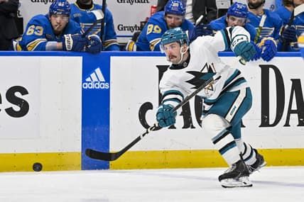 Mar 30, 2024; St. Louis, Missouri, USA;  San Jose Sharks defenseman Kyle Burroughs (4) shoots against the St. Louis Blues during the third period at Enterprise Center. Mandatory Credit: Jeff Curry-USA TODAY Sports