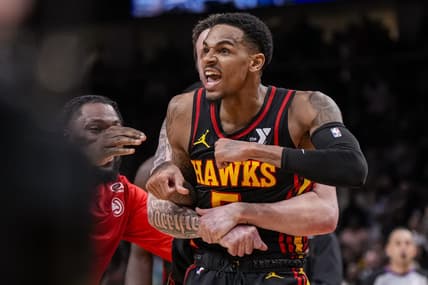 Mar 28, 2024; Atlanta, Georgia, USA; Atlanta Hawks guard Dejounte Murray (5) reacts after making a go ahead basket with less than a second left against the Boston Celtics during overtime at State Farm Arena. Mandatory Credit: Dale Zanine-USA TODAY Sports