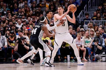 Apr 2, 2024; Denver, Colorado, USA; Denver Nuggets center Nikola Jokic (15) controls the ball as San Antonio Spurs center Victor Wembanyama (1) and guard Devonte' Graham (4) defend in the second quarter at Ball Arena. Mandatory Credit: Isaiah J. Downing-USA TODAY Sports