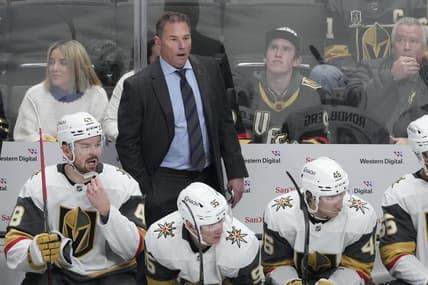 Vegas Golden Knights head coach Bruce Cassidy, standing, reacts from behind players on the bench during the third period of an NHL hockey game against the San Jose Sharks in San Jose, Calif., Tuesday, Jan. 7, 2025. (AP Photo/Jeff Chiu)