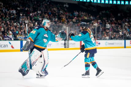 New York Sirens goalie Kayle Osborne fist bumps rookie forward Casey O'Brien.