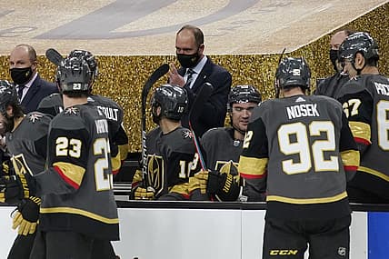 Feb 5, 2021; Las Vegas, Nevada, USA; Vegas Golden Knights head coach Peter DeBoer, center, speaks with his players during the second period of an NHL hockey game against the Los Angeles Kings, Friday, Feb. 5, 2021, in Las Vegas at T-Mobile Arena. Mandatory Credit: John Locher/Pool Photo-USA TODAY Sports