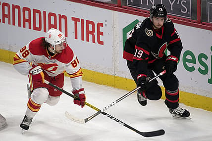 Feb 27, 2021; Ottawa, Ontario, CAN; Calgary Flamesleft wing Andrew Mangiapane (88) chases Ottawa Senators right wing Drake Batherson (19) in the third period at the Canadian Tire Centre. Mandatory Credit: Marc DesRosiers-USA TODAY Sports
