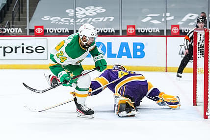 Feb 27, 2021; Saint Paul, Minnesota, USA; Minnesota Wild defenseman Matt Dumba (24) scores a goal against Los Angeles Kings goaltender Calvin Petersen (40) in overtime at Xcel Energy Center. Mandatory Credit: David Berding-USA TODAY Sports