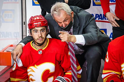 Mar 13, 2021; Calgary, Alberta, CAN; Calgary Flames head coach Darryl Sutter on his bench with left wing Johnny Gaudreau (13) during the third period against the Montreal Canadiens at Scotiabank Saddledome. Mandatory Credit: Sergei Belski-USA TODAY Sports