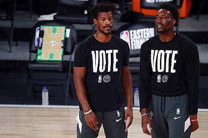 Sep 19, 2020; Lake Buena Vista, Florida, USA; Miami Heat forward Jimmy Butler (left) and forward Bam Adebayo (right) look on as the Heat warm up before the first half of game three of the Eastern Conference Finals of the 2020 NBA Playoffs against the Boston Celtics at ESPN Wide World of Sports Complex. Mandatory Credit: Kim Klement-USA TODAY Sports
