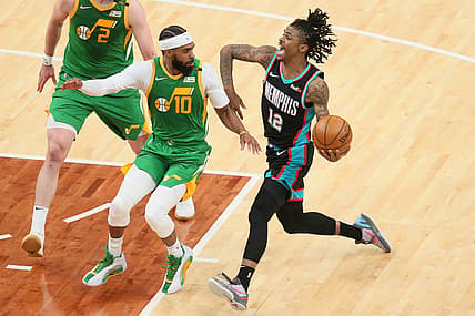 Mar 31, 2021; Memphis, Tennessee, USA; Memphis Grizzlies guard Ja Morant (12) drives against Utah Jazz guard Mike Conley (10) during the fourth quarter at FedExForum. Utah won 111-107. Mandatory Credit: Nelson Chenault-USA TODAY Sports