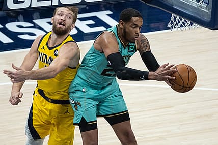 Apr 2, 2021; Indianapolis, Indiana, USA; Charlotte Hornets forward P.J. Washington (25) rebounds the ball over Indiana Pacers forward Domantas Sabonis (11) in the second quarter at Bankers Life Fieldhouse. Mandatory Credit: Trevor Ruszkowski-USA TODAY Sports