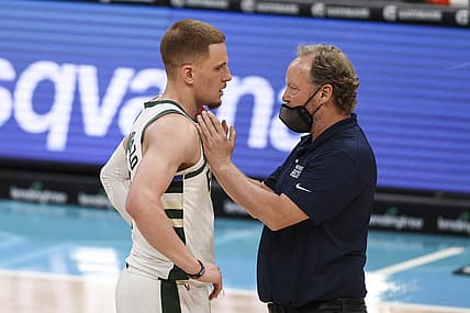 Apr 27, 2021; Charlotte, North Carolina, USA; Milwaukee Bucks coach Mike Budenholzer, right, talks to Milwaukee Bucks guard Donte DiVincenzo (0) during a break in the action against the Charlotte Hornets in the second quarter at Spectrum Center. Mandatory Credit: Nell Redmond-USA TODAY Sports
