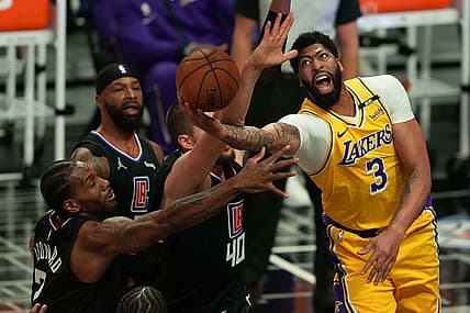 May 6, 2021; Los Angeles, California, USA; Los Angeles Lakers forward Anthony Davis (3) is defended by LA Clippers forward Kawhi Leonard (2) and center Ivica Zubac (40) in the first half at Staples Center. Mandatory Credit: Kirby Lee-USA TODAY Sports