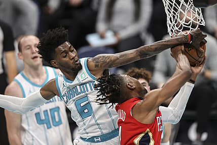 May 9, 2021; Charlotte, North Carolina, USA; Charlotte Hornets forward Jalen McDaniels (6) blocks shot by New Orleans Pelicans forward Wes Iwundu (4) in the second quarter at Spectrum Center. Mandatory Credit: Nell Redmond-USA TODAY Sports