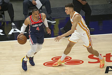 May 10, 2021; Atlanta, Georgia, USA; Washington Wizards guard Russell Westbrook (4) is defended by Atlanta Hawks guard Bogdan Bogdanovic (13) in the first quarter at State Farm Arena. Mandatory Credit: Brett Davis-USA TODAY Sports