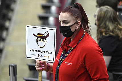 May 12, 2021; Cleveland, Ohio, USA; An arena usher holds a mask sign in the third quarter of a game between the Cleveland Cavaliers and the Boston Celtics at Rocket Mortgage FieldHouse. Mandatory Credit: David Richard-USA TODAY Sports