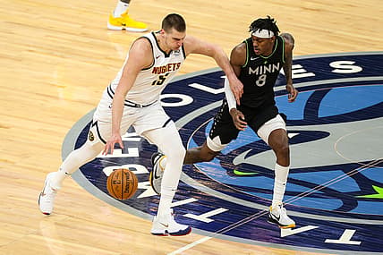 May 13, 2021; Minneapolis, Minnesota, USA; Denver Nuggets center Nikola Jokic (15) dribbles the ball while Minnesota Timberwolves forward Jarred Vanderbilt (8) defends in the first quarter at Target Center. Mandatory Credit: David Berding-USA TODAY Sports