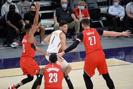 May 13, 2021; Phoenix, Arizona, USA; Phoenix Suns guard Devin Booker (1) controls the ball against Portland Trail Blazers defenders during the first half at Phoenix Suns Arena. Mandatory Credit: Joe Camporeale-USA TODAY Sports