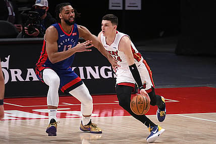 May 16, 2021; Detroit, Michigan, USA; Miami Heat guard Tyler Herro (14) drives to the basket as Detroit Pistons center Jahlil Okafor (13) defends during the first quarter at Little Caesars Arena. Mandatory Credit: Tim Fuller-USA TODAY Sports
