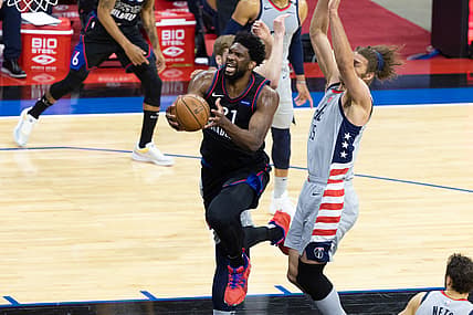 May 26, 2021; Philadelphia, Pennsylvania, USA; Philadelphia 76ers center Joel Embiid (21) drives for a shot against Washington Wizards center Robin Lopez (15) and forward Davis Bertans (42) during the second quarter of game two in the first round of the 2021 NBA Playoffs at Wells Fargo Center. Mandatory Credit: Bill Streicher-USA TODAY Sports
