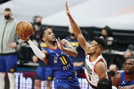 May 27, 2021; Portland, Oregon, USA; Denver Nuggets point guard Monte Morris (11) shoots the ball against Portland Trail Blazers shooting guard CJ McCollum (3) during the first half of game three in the first round of the 2021 NBA Playoffs at Moda Center. Mandatory Credit: Soobum Im-USA TODAY Sports