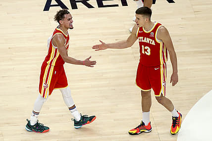 May 28, 2021; Atlanta, Georgia, USA; Atlanta Hawks guard Trae Young (11) and guard Bogdan Bogdanovic (13) celebrate against the New York Knicks in the fourth quarter during game three in the first round of the 2021 NBA Playoffs at State Farm Arena. Mandatory Credit: Brett Davis-USA TODAY Sports