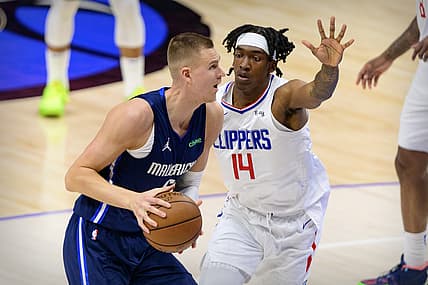 May 28, 2021; Dallas, Texas, USA; LA Clippers guard Terance Mann (14) guards Dallas Mavericks center Kristaps Porzingis (6) during the second quarter in game three in the first round of the 2021 NBA Playoffs at American Airlines Center. Mandatory Credit: Jerome Miron-USA TODAY Sports