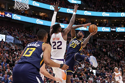 Feb 24, 2020; Salt Lake City, Utah, USA; Utah Jazz forward Royce O'Neale (23) shoots an off-balance shot over Phoenix Suns center Deandre Ayton (22) during the second quarter at Vivint Smart Home Arena. Mandatory Credit: Chris Nicoll-USA TODAY Sports