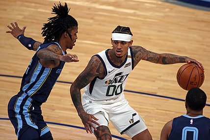 May 31, 2021; Memphis, Tennessee, USA; Utah Jazz guard Jordan Clarkson (00) dribbles as Memphis Grizzlies guard Ja Morant (12) defends during the third quarter during game four in the first round of the 2021 NBA Playoffs at FedExForum. Mandatory Credit: Petre Thomas-USA TODAY Sports
