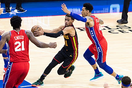 Jun 6, 2021; Philadelphia, Pennsylvania, USA; Atlanta Hawks guard Trae Young (11) drives against Philadelphia 76ers forward Danny Green (14) and center Joel Embiid (21) during the third quarter of game one in the second round of the 2021 NBA Playoffs at Wells Fargo Center. Mandatory Credit: Bill Streicher-USA TODAY Sports