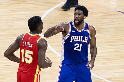 Jun 16, 2021; Philadelphia, Pennsylvania, USA; Philadelphia 76ers center Joel Embiid (21) reacts against Atlanta Hawks center Clint Capela (15) after a guard Ben Simmons (not pictured) dunk during the first quarter in game five of the second round of the 2021 NBA Playoffs at Wells Fargo Center. Mandatory Credit: Bill Streicher-USA TODAY Sports