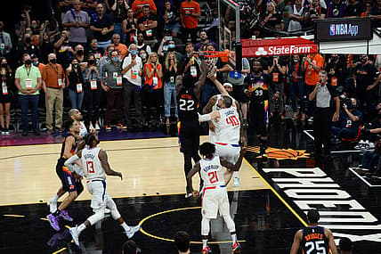 Jun 22, 2021; Phoenix, Arizona, USA; Phoenix Suns center Deandre Ayton (22) dunks over LA Clippers center Ivica Zubac (40) in the final second during the second half of game two of the Western Conference Finals for the 2021 NBA Playoffs at Phoenix Suns Arena. Mandatory Credit: Joe Camporeale-USA TODAY Sports