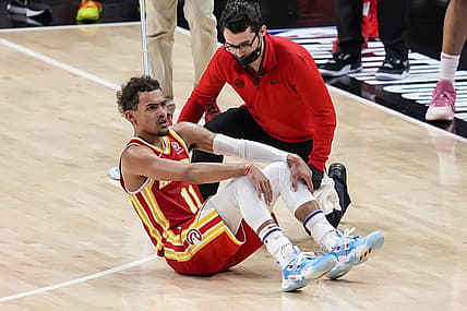 Jun 27, 2021; Atlanta, Georgia, USA; Atlanta Hawks guard Trae Young (11) is attended to after injuring his foot by accidentally stepping on an official's foot against the Milwaukee Bucks in the second half during game three of the Eastern Conference Finals for the 2021 NBA Playoffs at State Farm Arena. Mandatory Credit: Dale Zanine-USA TODAY Sports